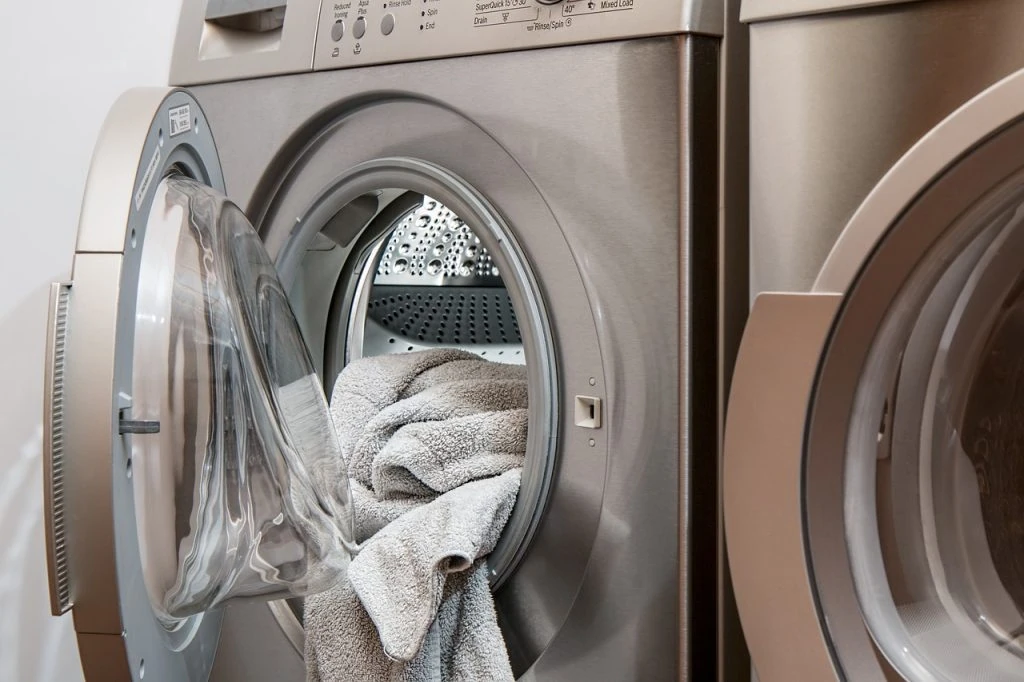 Laundry machine handing freshly dry-cleaned clothes to a customer.